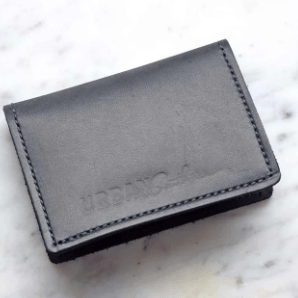 Full-grain leather bifold card wallet with multiple card slots, durable stitching, compact design for everyday organization, and effortless style. Black