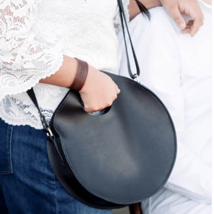 Britt Full-Grain Leather Circle Crossbody Bag, handcrafted design with adjustable strap, ideal for hands-free everyday style and versatile outfits. Black