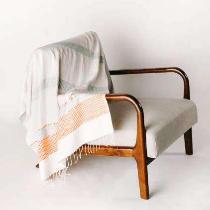 Camden throw: soft, versatile textile perfect for layering on sofas, chairs, or beds, adding warmth, texture, and a stylish accent to home décor.  Azure & Tangerine