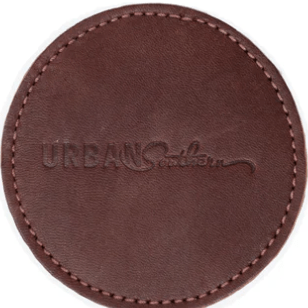 Round leather coaster in chestnut brown, handcrafted to protect surfaces and add style to your home.