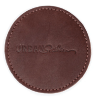 Round leather coaster in chestnut brown, handcrafted to protect surfaces and add style to your home.