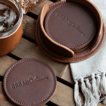 Set of round leather coasters in Rustic Brown, handcrafted to protect surfaces and add style to your home.