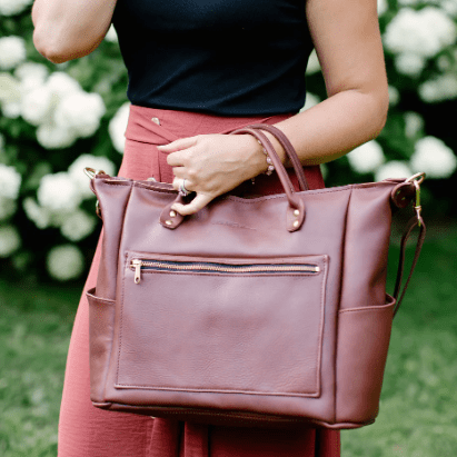 Legacy Backpack Tote is a versatile and stylish bag designed for everyday use, featuring comfortable straps and durable construction.  Chestnut Brown