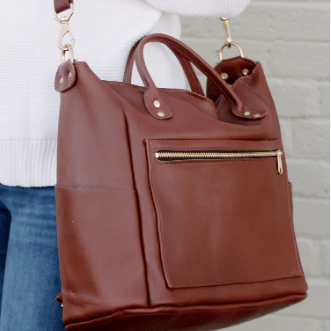 Legacy Backpack Tote is a versatile and stylish bag designed for everyday use, featuring comfortable straps and durable construction.  Chestnut Brown