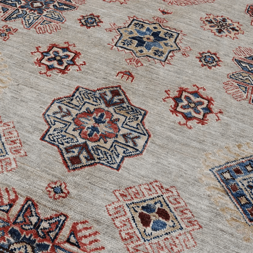 Loomier Ghazni handmade wool area rug in earth tones with blue accents, hand-knotted for durability and style, ideal for living rooms, bedrooms, or cozy corners. Close-up