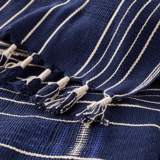 Nagaland Kiphire handcrafted cotton throw blanket featuring the Imena tribal design in royal blue and ivory; artisan-woven textile adding cultural artistry and soft comfort to sofas, chairs, or beds.
