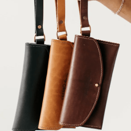 Ruby leather wristlet wallet with secure zip closure, compact design for essentials, versatile accessory for everyday use.