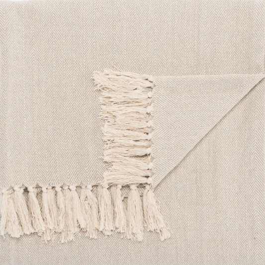 Seabreeze handcrafted cotton throw blanket in herringbone stripe pattern; soft, breathable textile ideal for layering on sofas, chairs, or beds, adding coastal-inspired style to home décor. Beige