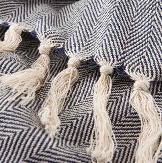 Seabreeze handcrafted cotton throw blanket in herringbone stripe pattern; soft, breathable textile ideal for layering on sofas, chairs, or beds, adding coastal-inspired style to home décor.   Charcoal