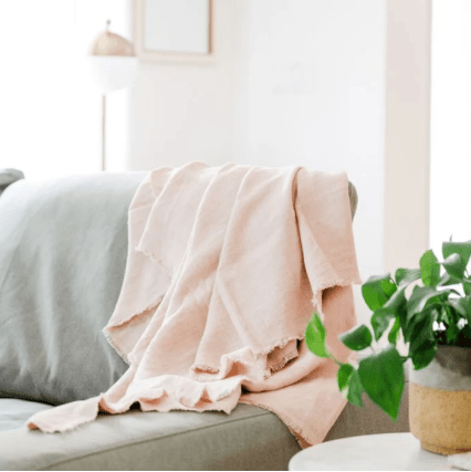 Stonewashed linen throw; soft, lightweight, and durable textile perfect for layering on sofas, chairs, or beds, adding casual elegance and cozy texture to home décor.