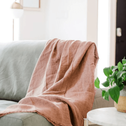 Stonewashed linen throw; soft, lightweight, and durable textile perfect for layering on sofas, chairs, or beds, adding casual elegance and cozy texture to home décor.