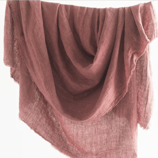 Stonewashed linen throw; soft, lightweight, and durable textile perfect for layering on sofas, chairs, or beds, adding casual elegance and cozy texture to home décor.