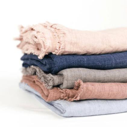 Stonewashed linen throw; soft, lightweight, and durable textile perfect for layering on sofas, chairs, or beds, adding casual elegance and cozy texture to home décor.