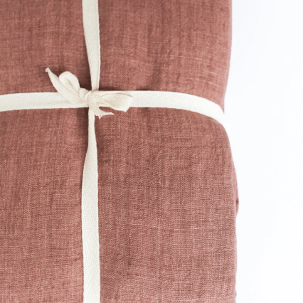 Stonewashed linen throw; soft, lightweight, and durable textile perfect for layering on sofas, chairs, or beds, adding casual elegance and cozy texture to home décor.