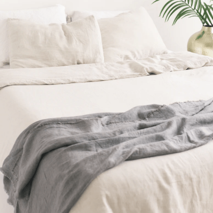 Stonewashed linen throw; soft, lightweight, and durable textile perfect for layering on sofas, chairs, or beds, adding casual elegance and cozy texture to home décor.